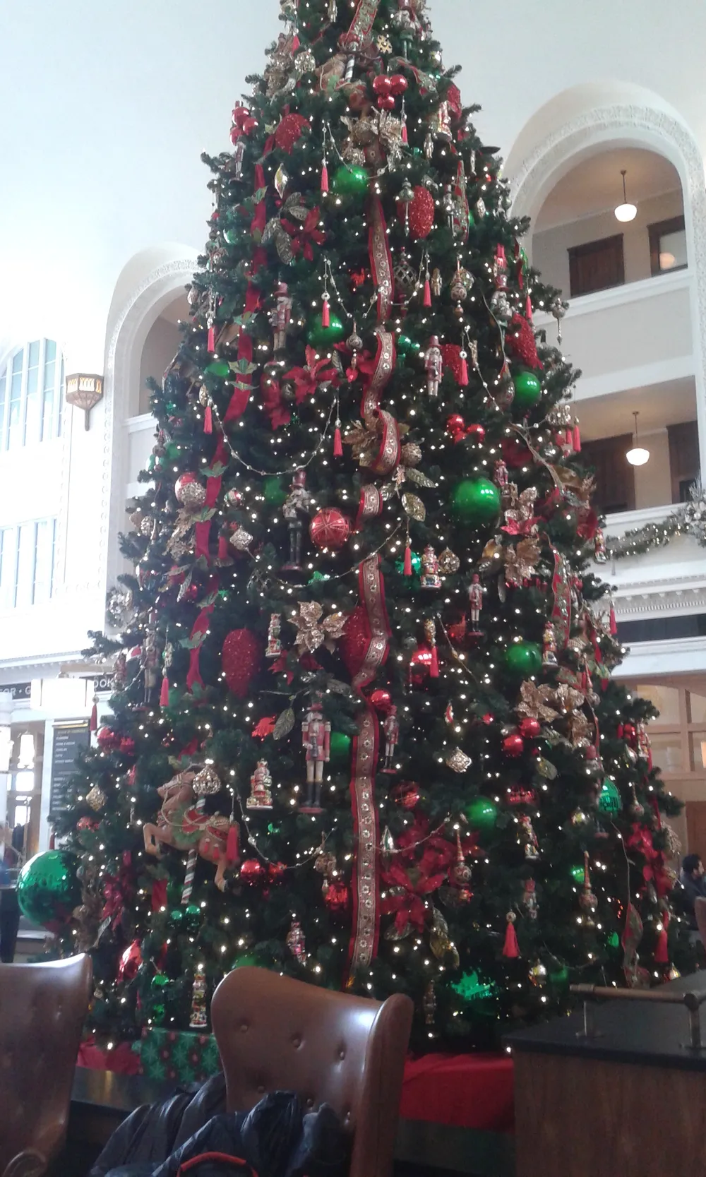 A tall decorated Christmas tree in the Great Hall of Denver Union Station