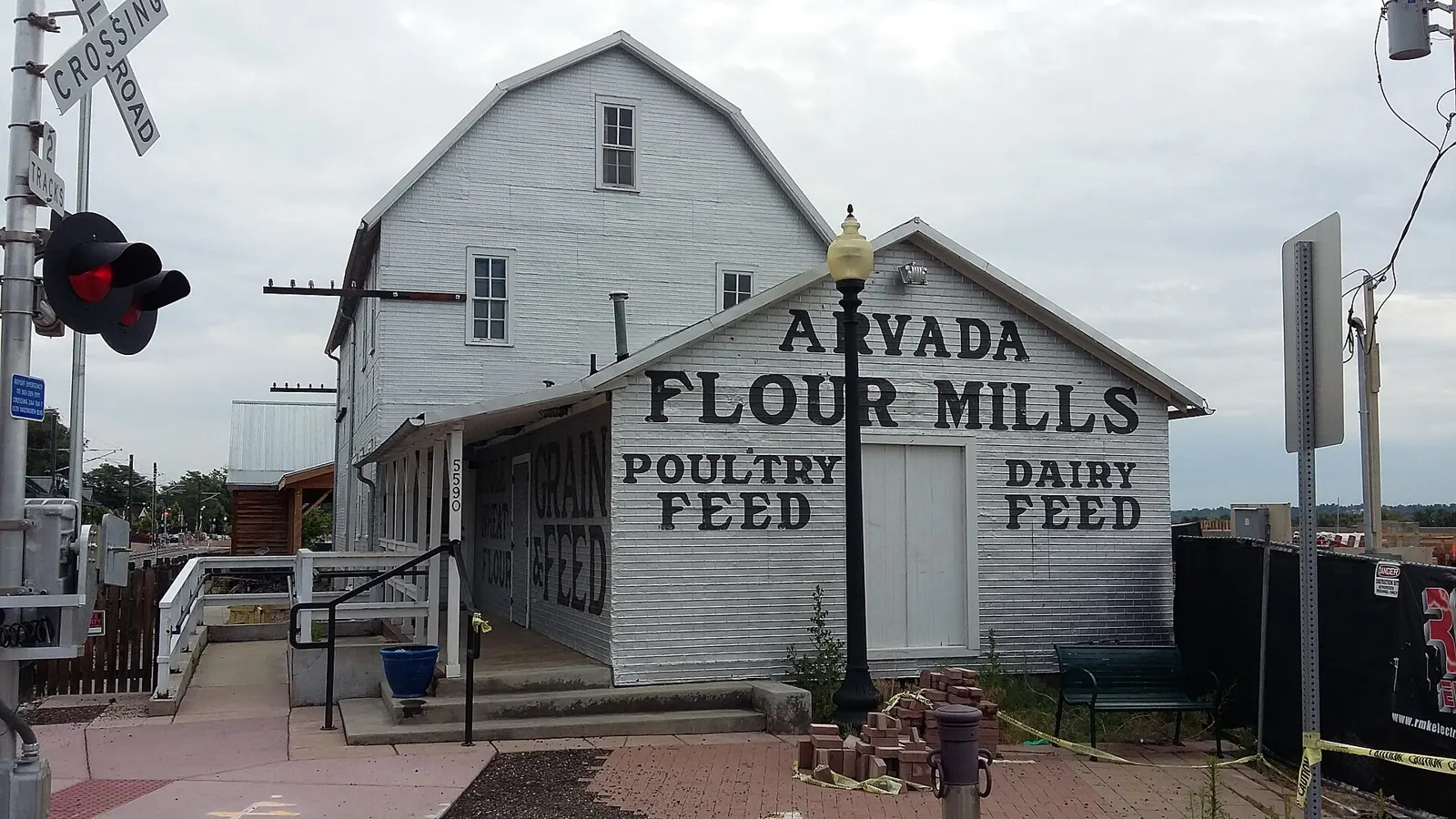 The white historic Arvada Flour Mills building in Olde Town Arvada, Colorado