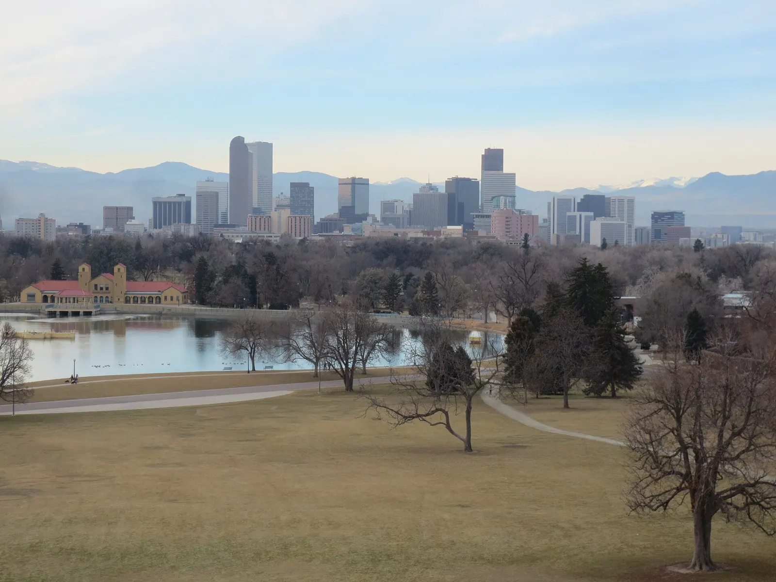 Downtown Denver skyline and the Front Range mountains seen across Ferril Lake and City Park